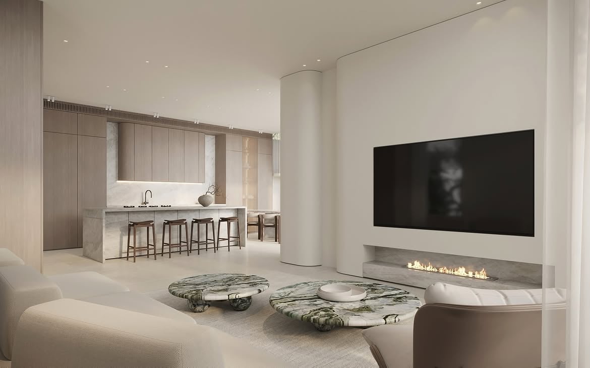 Vista del living con hogar lineal, mesas bajas y cocina integrada
