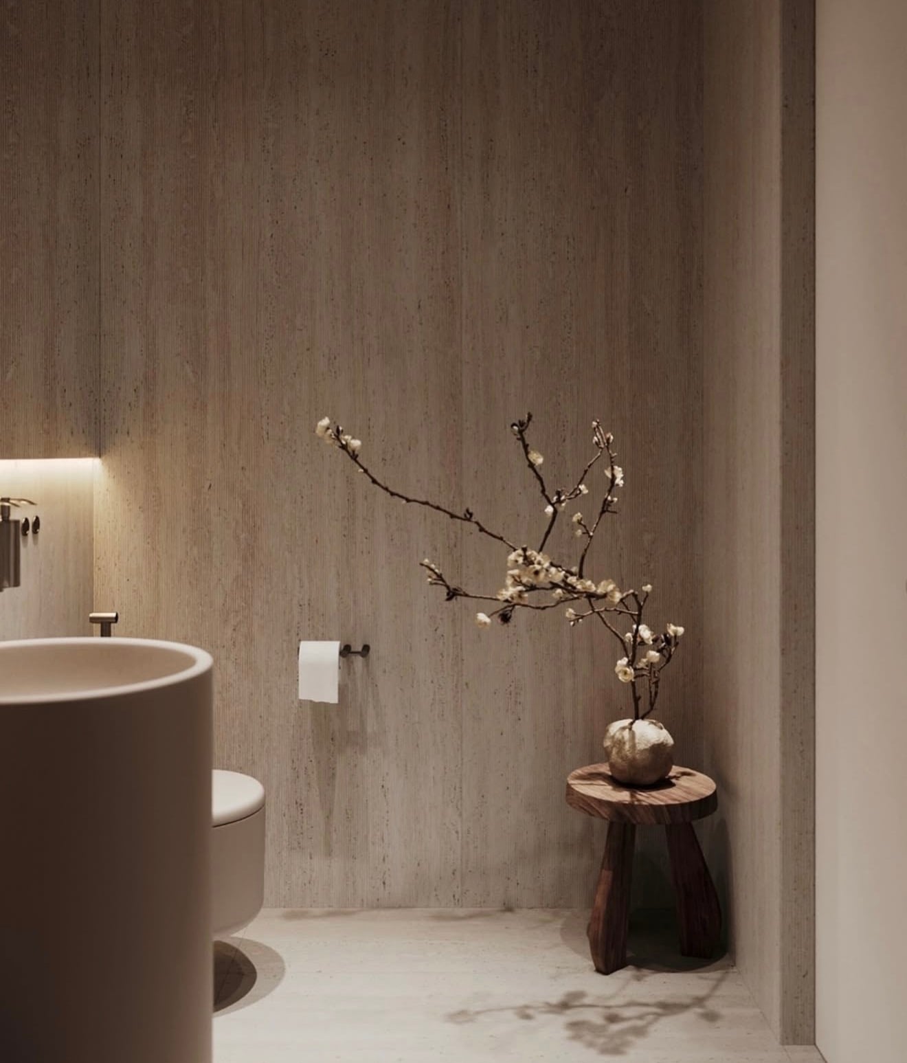Vista del toilette con iluminación indirecta y una mesa auxiliar